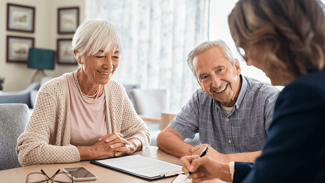Occupational therapist taking notes during an in-home consultation with a client.